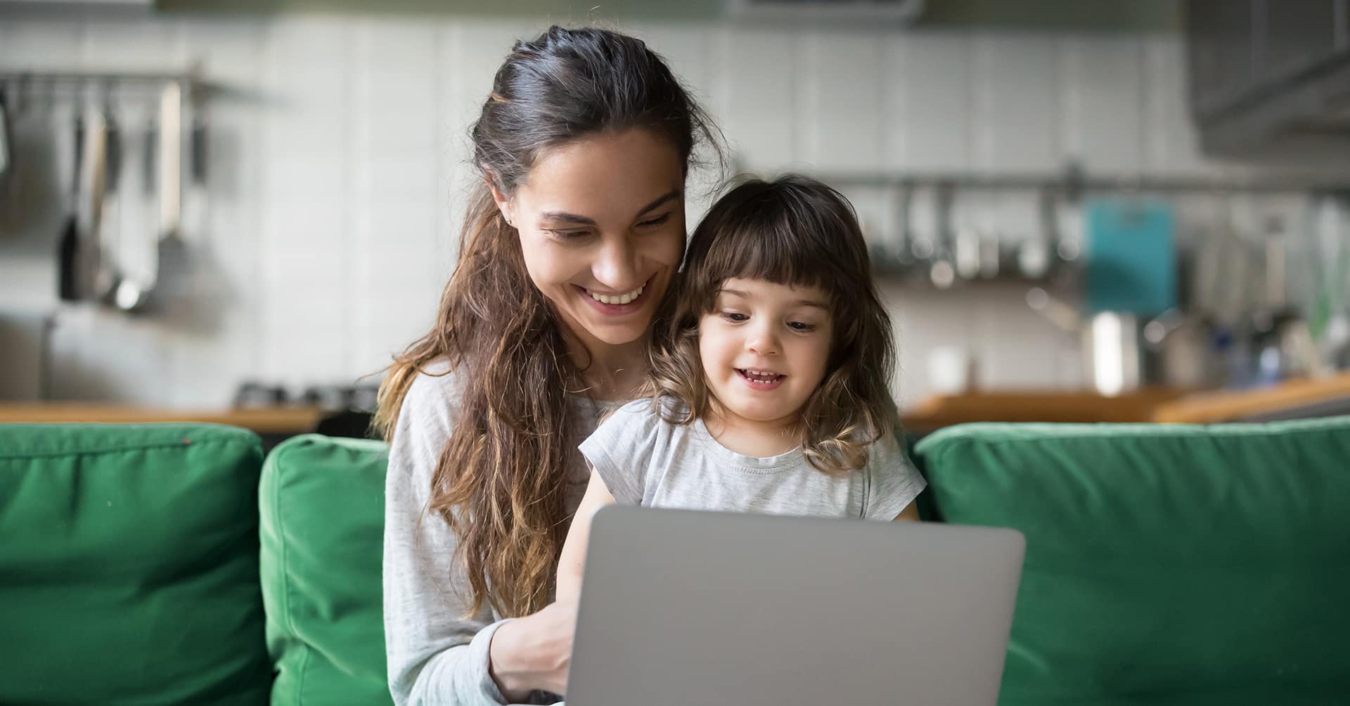 mother and daughter looking at a computer screen together